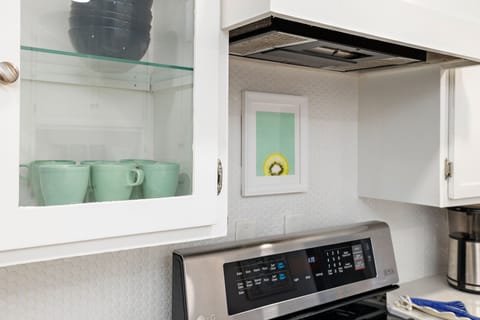 The Kitchen has stainless steel appliances and bright, white cabinets.