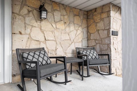 Front porch with seating area overlooking front yard