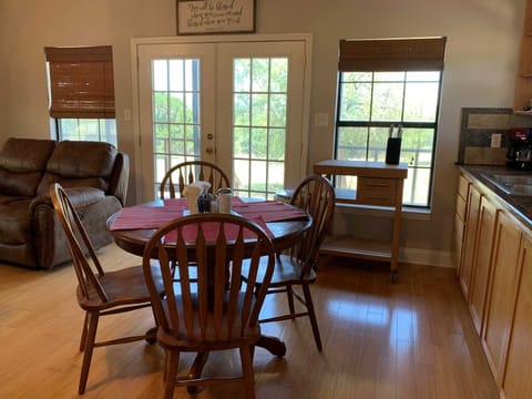 Seating up to four, the dining room table is positioned right by windows and French doors for a beautiful view of the great outdoors.