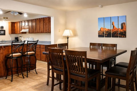 Spacious dining area seats 8 at the table plus 2 at the kitchen counter.