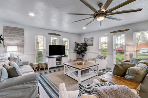 Huge Living Area Featuring 2 Full Size Sofas, 2 Swivel Glider Chairs and a Large Flat Screen Smart TV