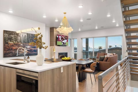 Bright and modern open-concept living space with mountain views – perfect for relaxing after a day on the slopes!