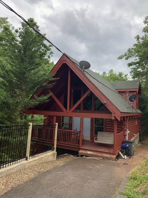 Front porch with a swing and hot tub. Only two small steps to enter the cabin