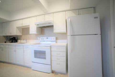 Full Kitchen with Fridge, Freezer, stove, microwave, and cooking utensils