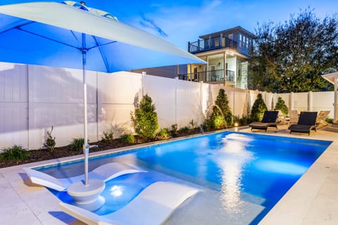 Large Private Pool with Sunshade, in pool lounge chairs!! Spacious Pool Deck with a Fire Pit and covered Dining Area!! This Backyard is Completely Enclosed.