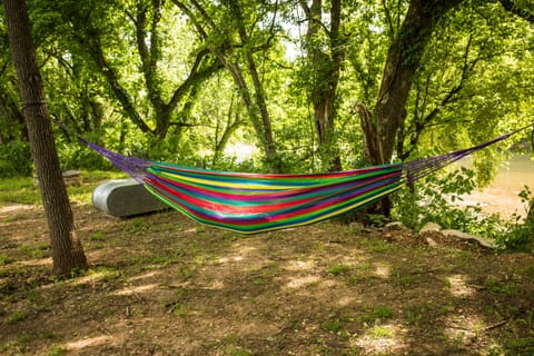 Firepit, hammock, and seating area down by river access