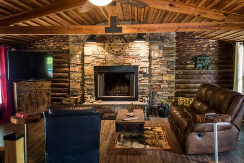 First living room upstairs with large TV, and large wood burning fireplace