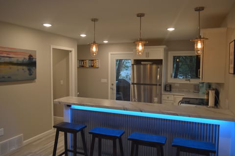 Bar seating area between living room and kitchen, looking out to the deck