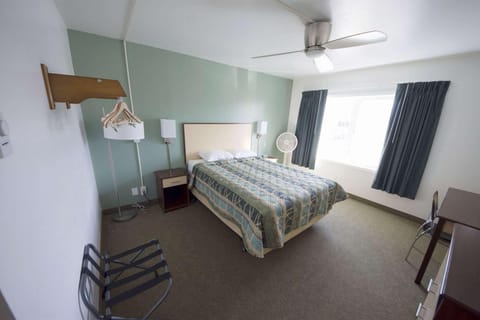 Bedroom interior with bed, lamp and hangers