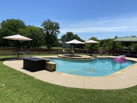 Large swimming pool with diving board and lights 