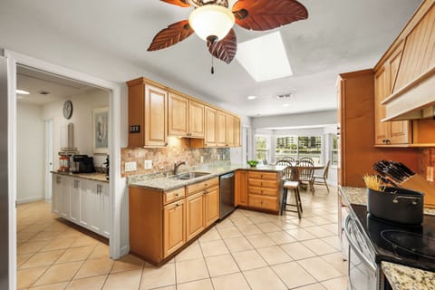 Galley kitchen opesn to breakfast nook & offers space for effortless meal prep.