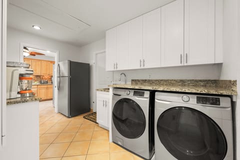 Laundry room includes Samsung washer & dryer  and a coffee bar area.