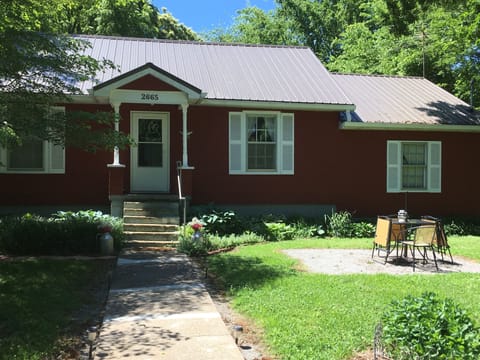 The table and chairs on the gravel area where a dead tree used to be. 
