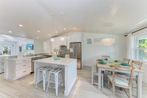 Your spacious kitchen features marble countertops, stainless steel appliances, and a charming dining nook where you can enjoy meals together.