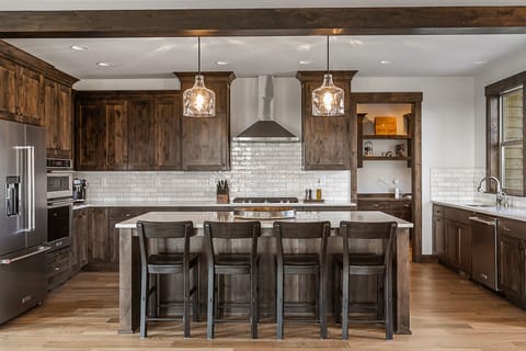 Comfortable bar seating for 4 to participate in the kitchen action