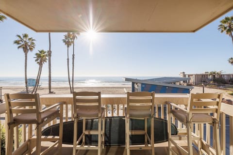 The balcony offers seating for four, perfect for enjoying beautiful ocean sunsets or sipping morning coffee while taking in the sunrise