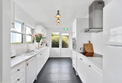 Experience culinary delight in the bright, fully-equipped kitchen with modern appliances, ample bench space, and all the essentials for home cooking.