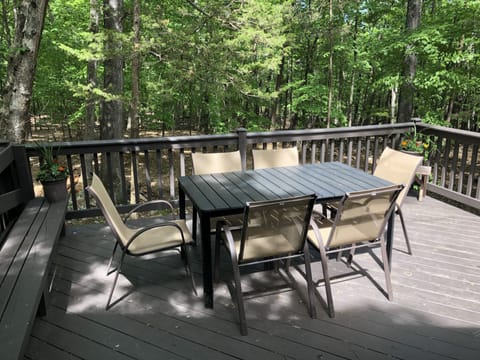 Large deck with patio table and seating for six.