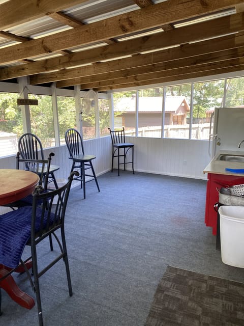 Extra seating on screened back porch with fans