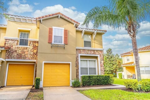 Beautiful shot of the front of your vacation townhome with lush green yard!