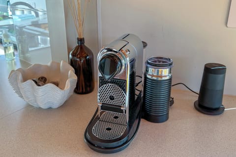 Nespresso pod machine, milk throther, and the Bose bluetooth sound speaker