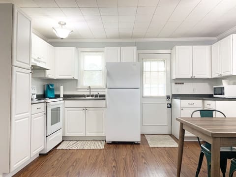 Open concept kitchen with kitchen table and seating for 4