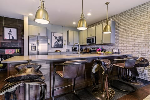 Pull Up a Genuine Horse Saddle Bar Stool, or Relax in a Rustic and Iron Scoop Seat Option.  Bar Seating for 5 Offered at our counter. In LOVE with this Bar Seating!