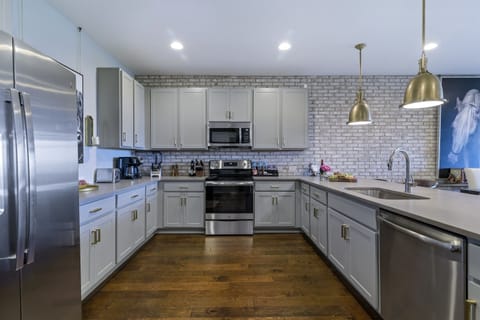 Huge, Luxury Kitchen is Fully Stocked with Appliances, Dining-ware and Bar Service Options.