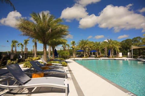The community pool has cabanas and loungers.