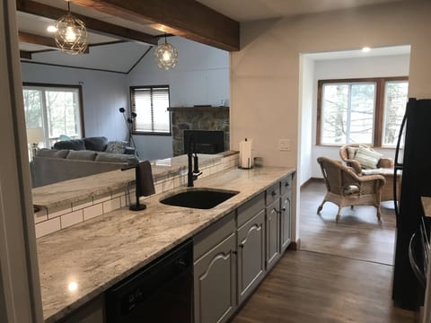 Kitchen w/ granite counters + breakfast bar