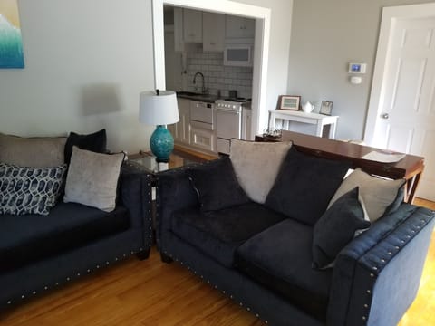 Comfortable sofa & loveseat in living room area. 