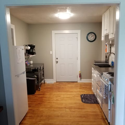 Full kitchen: microwave, stove/oven, prep cart, keurig, refrigerator, & DW.