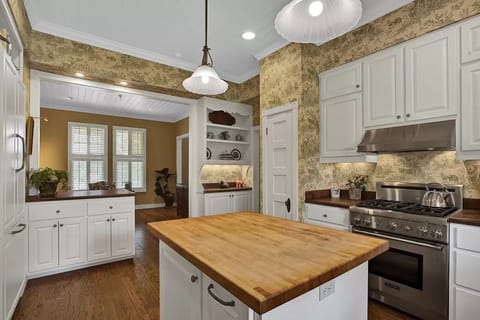 Butcher blk counter tops, high-end appliances, cookware in this large Kitchen.
