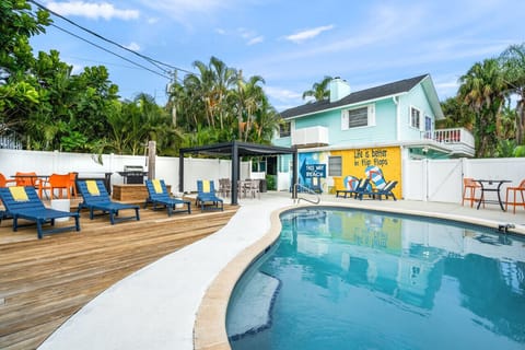 Welcome to your Florida getaway! Relax in a spacious backyard oasis with a sparkling pool, wide sun deck with loungers, and BBQ grill—perfect for laid-back afternoons, just a short stroll from the beach.