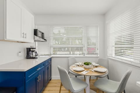 Siesta Key beach retreat with ocean-blue cabinets, sunny dining nook & coffee bar—designed for leisurely meals and coastal comfort.