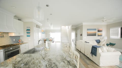 Screen porch view of kitchen, living and dining room