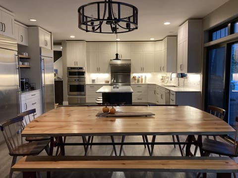 Large dining table seats 12, plus 4 at island and three at bar