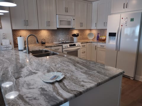 Newly remodeled (2025) kitchen with fully stocked appliances and utensils.