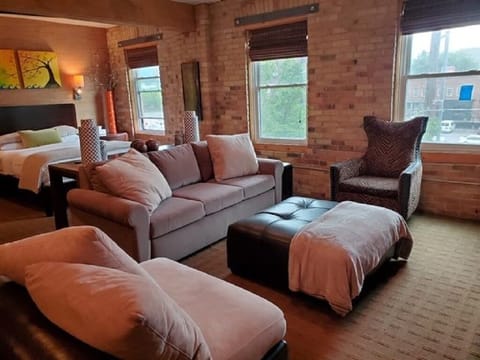 Large open living room area with brand new memory foam sofa sleeper.