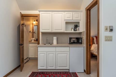 Upper level wet bar & entrance to shared bathroom