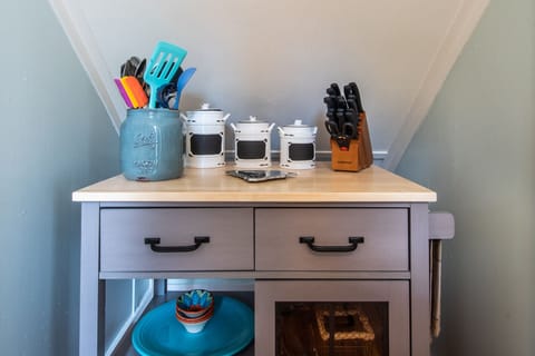 Portable pantry under staircase next to kitchen