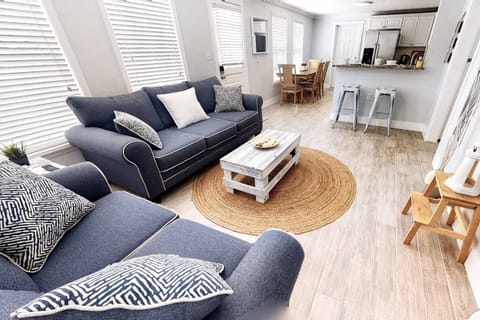 Beautiful living room area perfectly arranged around the wall-mounted flat screen...