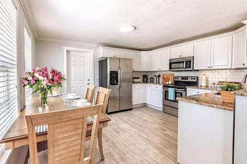 New kitchen is complete with dishes, glasses and basic appliances.