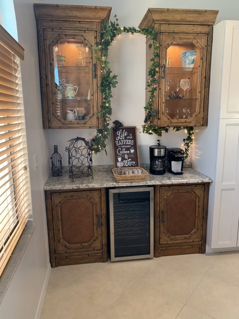 Lit coffee and wine bar with its own beverage refrigerator.