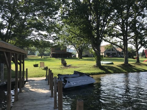 View of house from dock, large flat backyard