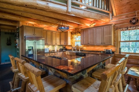 Kitchen w/ additional table seating off to side.