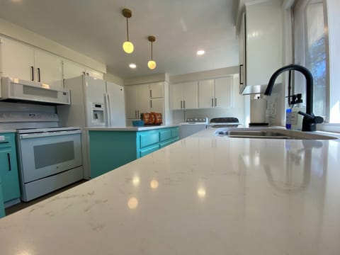 Newly remodeled Kitchen (2024) with quartz countertops, deep double stainless sink, and kitchen island.