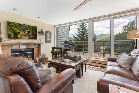 Living Room with Large Flat Screen TV and Wood Burning Fireplace!