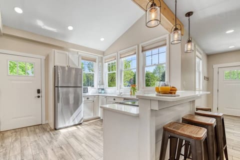 Welcome to our sunlit kitchen designed to brighten your day. Prepare a special meal or simply savor snacks at the breakfast bar where you will be embraced by the warm and inviting atmosphere. Natural light accentuates this vibrant design.