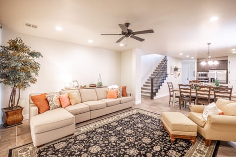 Family Room View Into Kitchen - The living room is designed as an open floor plan and is a great gathering place for meals, games, or watching TV during your stay.